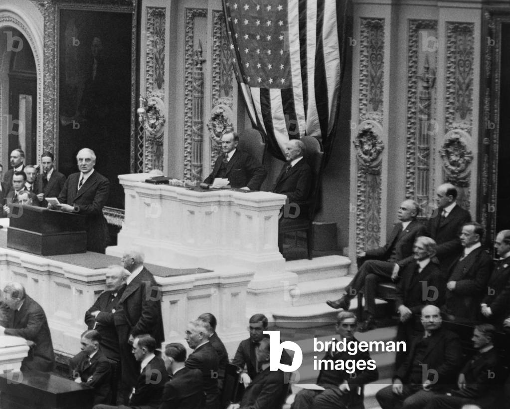 President Warren Harding speaking to a joint session of Congress. c. 1921-23. Behind him, in the speakers' rostrum are VP Calvin Coolidge and House Speaker Frederick Gillett