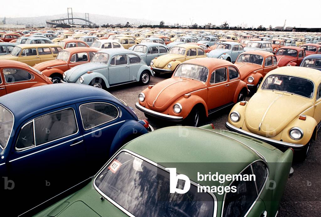 Imported Volkswagen Beetles on an American pier. These German cars Japanese cars were among the millions imported to compete with the large gas guzzling American cars. c.1973-75