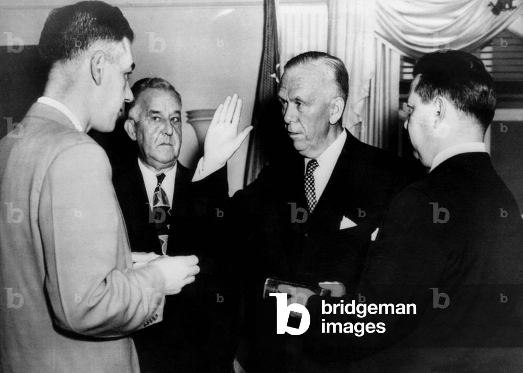 General George C. Marshall sworn in as Secretary of Defense. From left: Felix Larkin (General Counsel, Office of the Secretary of Defense), Stephen T. Early, General George C. Marshall, Major Clarence J. George, the Pentagon, Washington D.C., September 21, 1950.