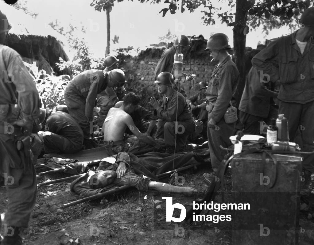 U.S. soldiers receive medical treatment at a first aid station near South Korean battle front. July 25, 1950. During the Battle of the Pusan Perimeter in the first month of the Korean War