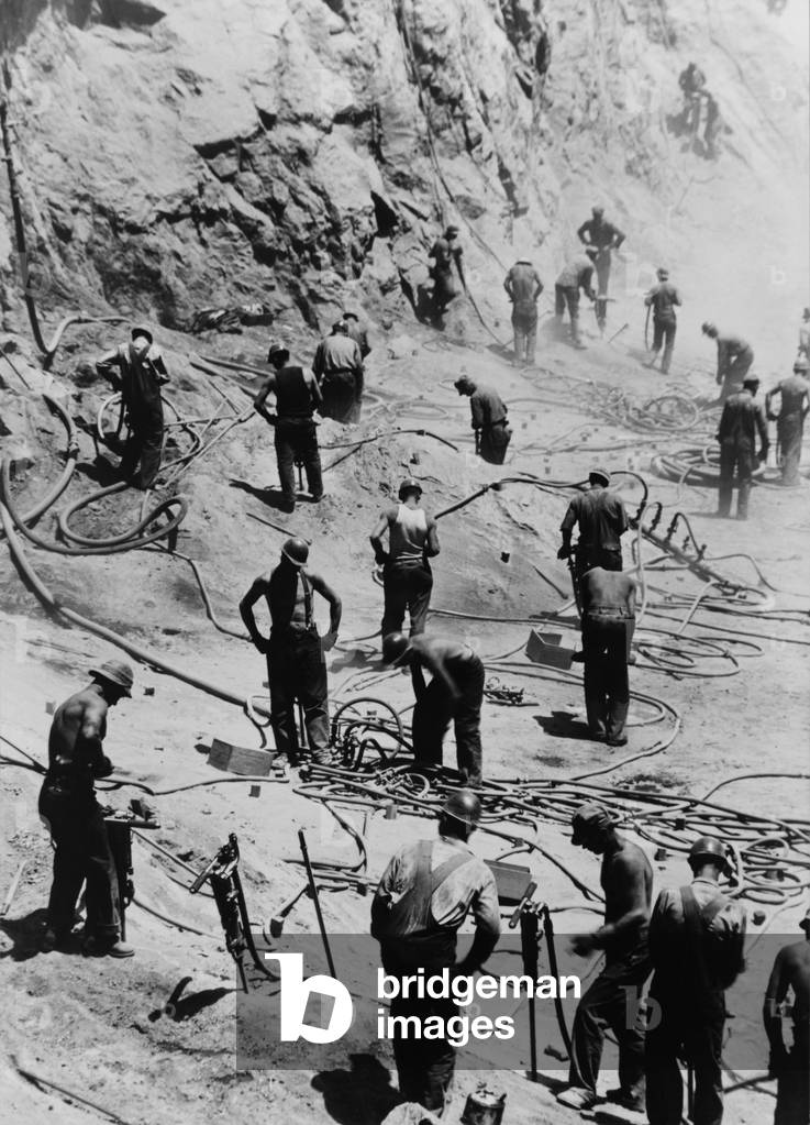 Drillers excavating the dam foundation on the Nevada site of Boulder dam, excavating the dam foundation. 1933