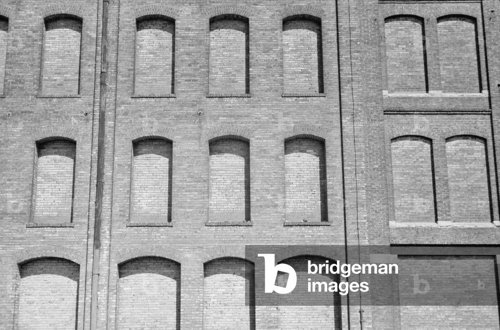 Factory windows bricked up for conversion to a warehouse in Minneapolis, Minnesota, during the Great Depression. 1939