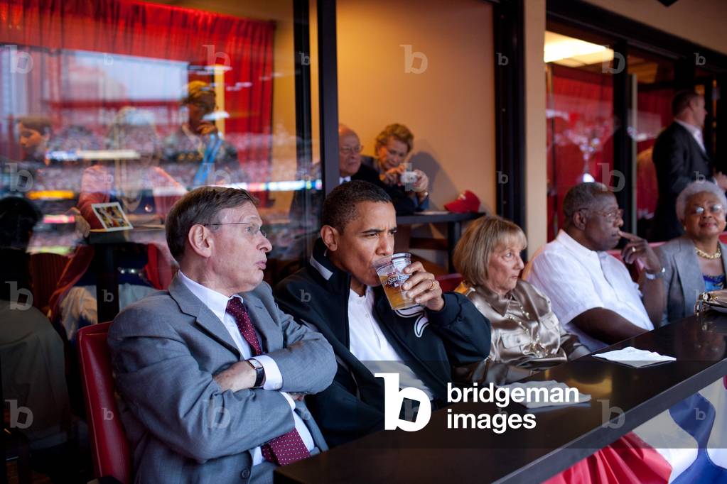 President Barack Obama watches the 2009 Major League Baseball All-Star Game with baseball commissioner Bud Selig left July 14 2009. At right in white shirt is baseball great Hank Aaron.,