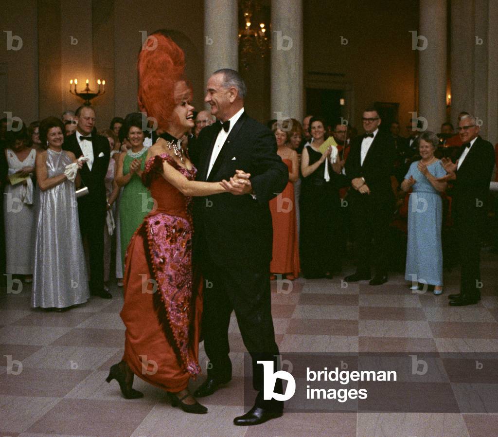 President Lyndon Johnson dancing with Carol Channing. Channing wears her costume from an earlier White House performance of the popular Broadway musical, 'Hello Dolly'. Jan. 17, 1967