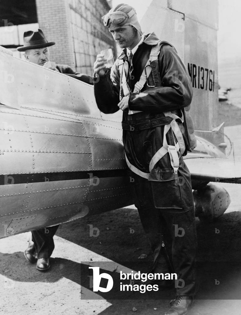Howard Hughes (1905-1976), in flight uniform, as he prepares to board airplane in Newark, N.J. 1946