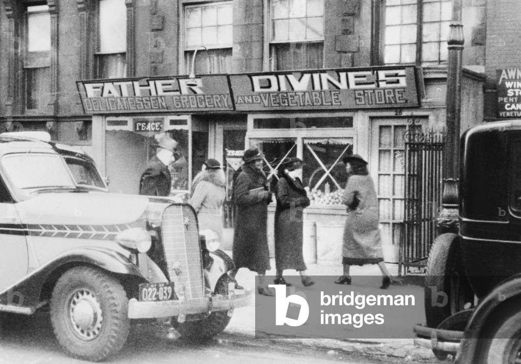 One of Father Divine's Peace Mission Movement grocery store that sells food at cost. Father Divine's mission included a network of businesses such as restaurants, gas stations, grocery and clothing stores, hotels, farms, and many other enterprises. All working followers were required to give Father Divine their paychecks and he provided housing, food and other necessities for all. c. 1936. -