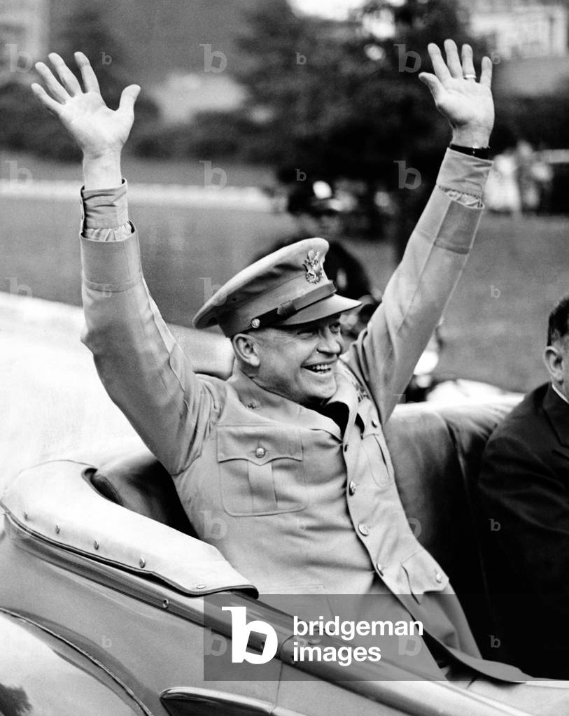 General Dwight Eisenhower raises both arms and acknowledges the New York crowd's cheers, June 6, 1945