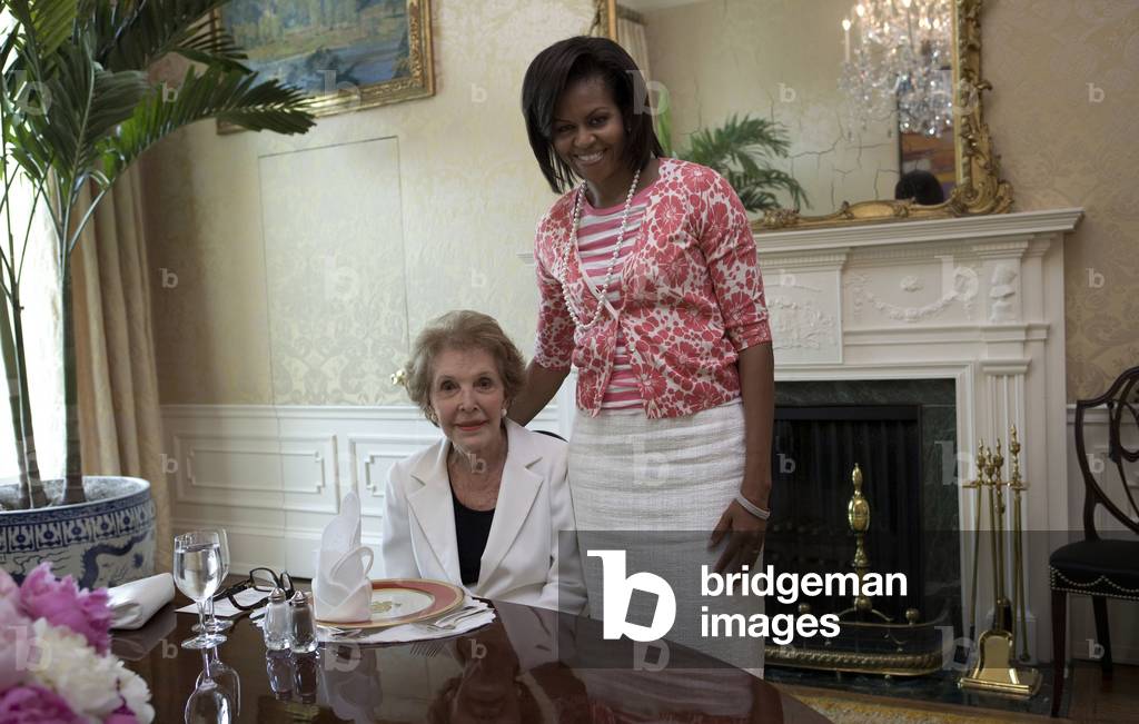 Michelle Obama visits with Former First Lady Nancy Reagan at the White House on June 3 2009. Michelle wears a floral printed cardigan from Gap.,