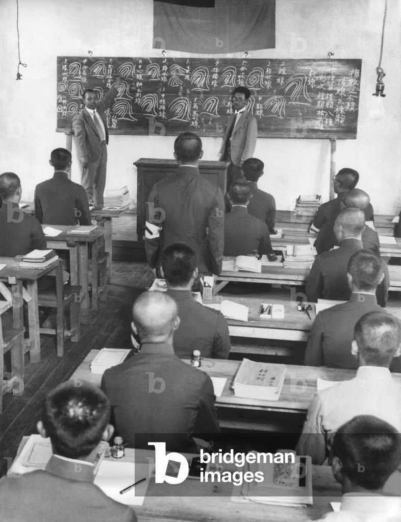 Japanese in Manchukuo create a new 100,000 police force in 60 days. Japanese instructors from Tokyo drill peasants in reading fingerprints. The instructor has an interpreter
