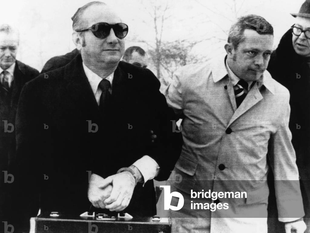 Bobby Baker in hand cuffs is escorted by U.S. Marshals into Lewisburg Penitentiary, Jan. 14, 1971. He serving 18 months in prison for fraud, theft, and income tax evasion