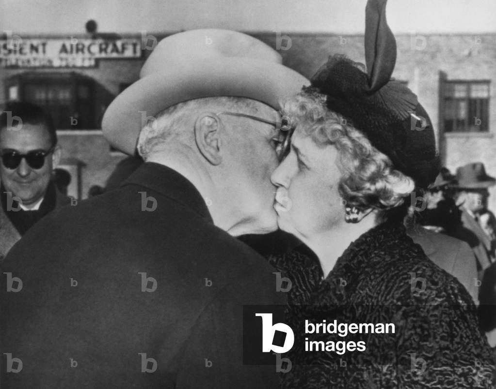 President Truman kisses his wife goodbye before boarding the plane for Washington. Mrs. Truman and their daughter Margaret, would remain in Missouri for an extended Holiday vacation. Dec. 29, 1949.