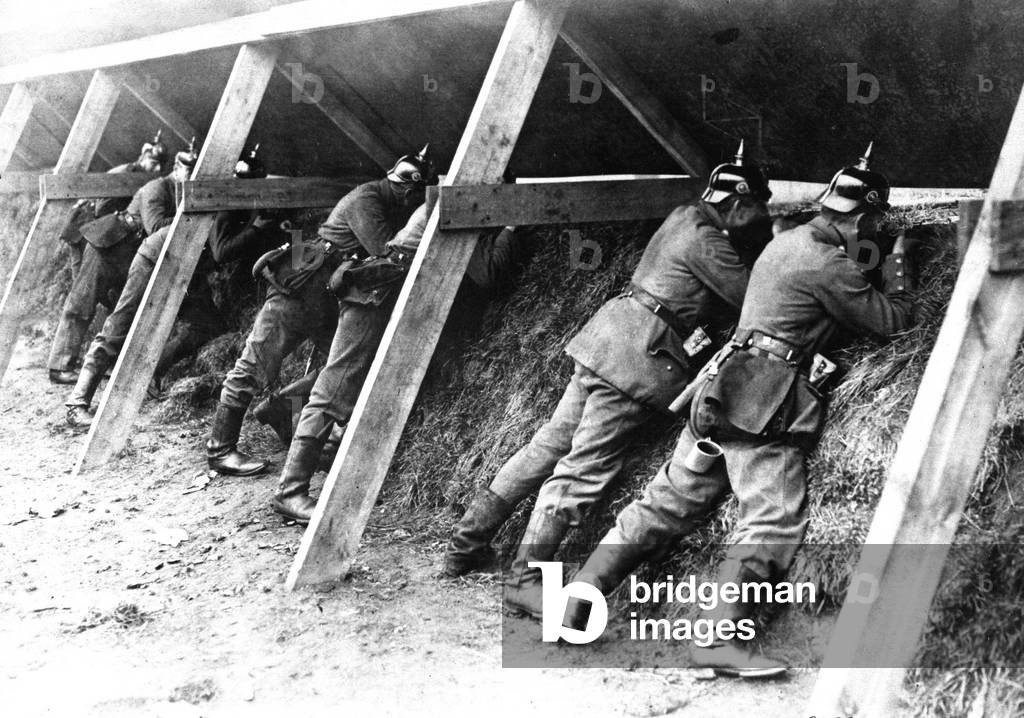 World War I German soldiers in their protected trenches on the Belgian frontier. The troops are aiming at the enemy. 1914-1918