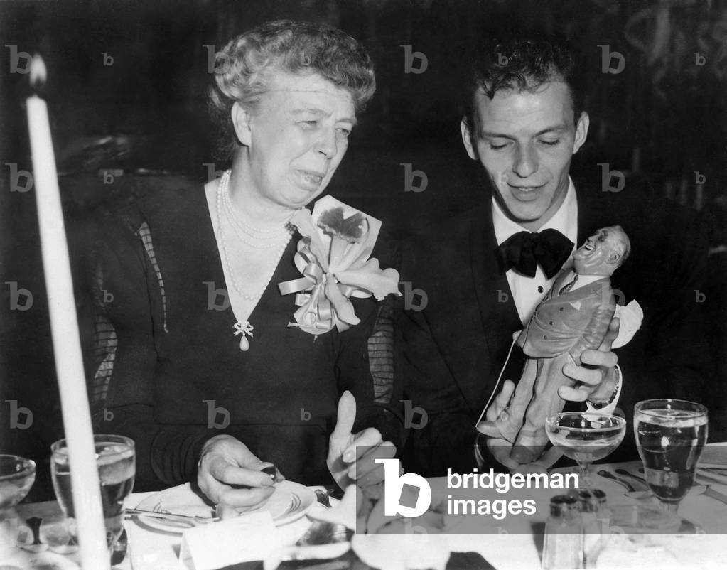 Eleanor Roosevelt and Frank Sinatra in Los Angeles. June 15, 1947. Sinatra is holding a figurine depicting the late President Franklin Roosevelt