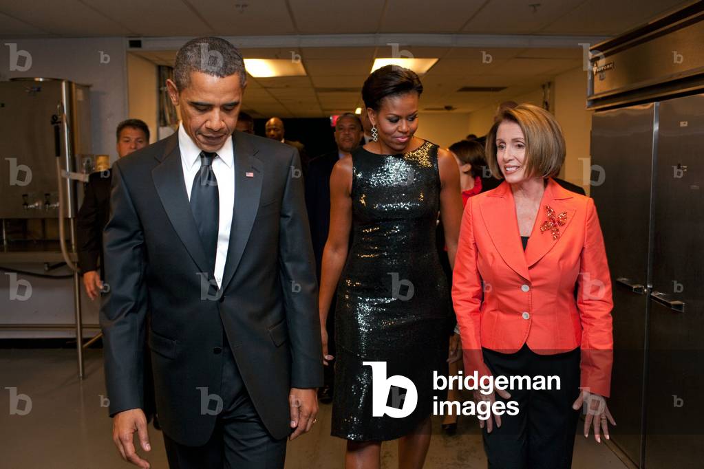 President and Michelle Obama and House Speaker Nancy Pelosi arrive at the 32nd Annual Awards Gala of the Congressional Hispanic Caucus. Michelle wears a black sequin sheath dress by Michael Kors. Sept. 16 2009.,