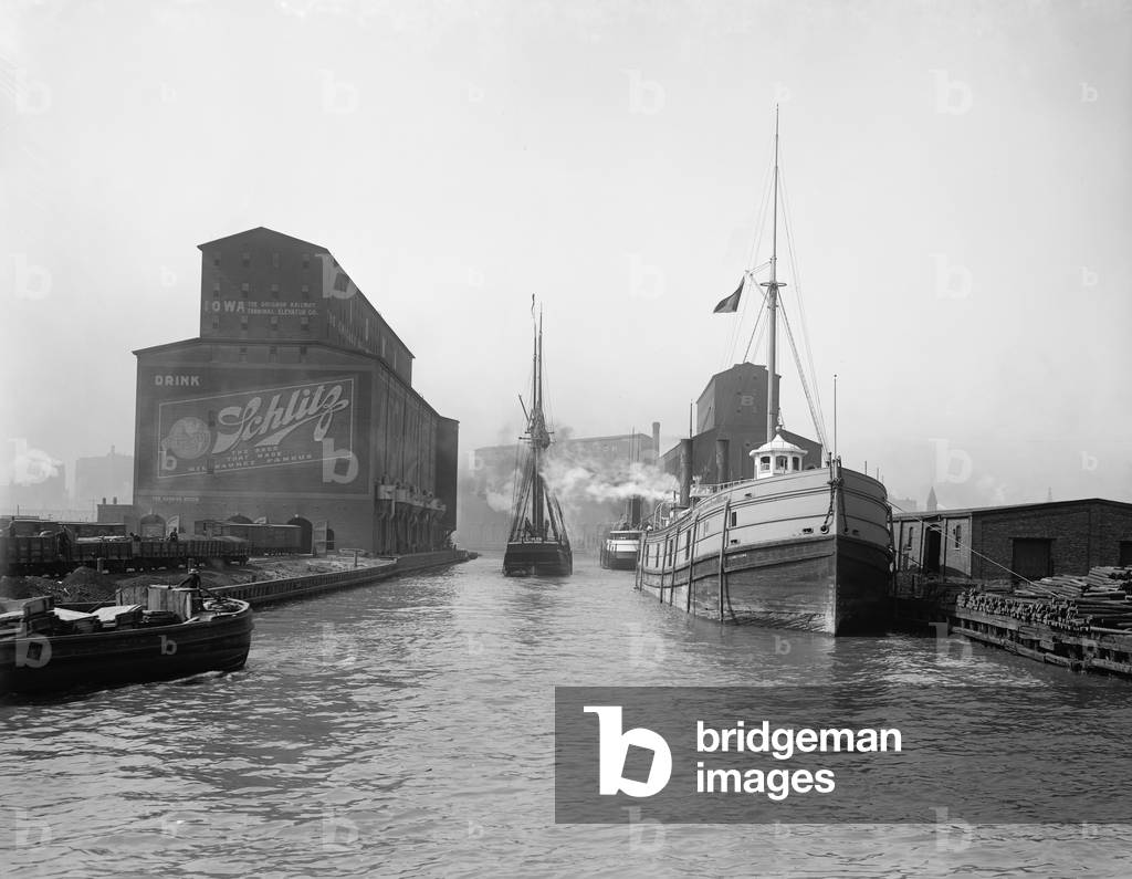 Cargo ships in the Chicago River. Warehouses and grain elevators line the urban river banks of the Port of Chicago. 1900. LC-D4-12626