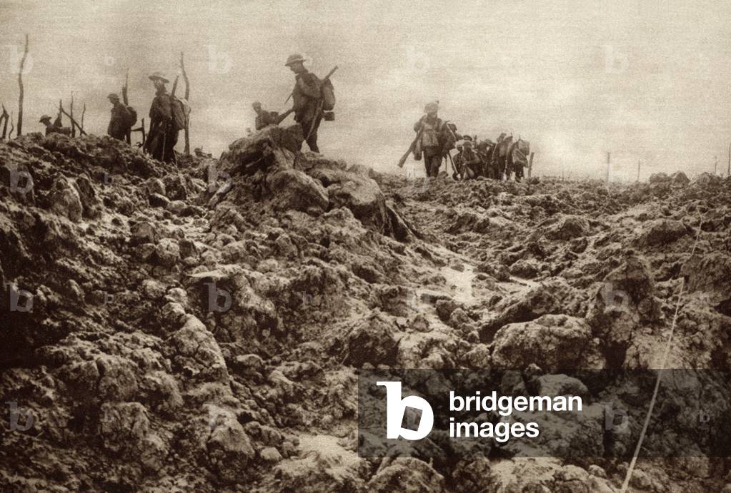 World War 1. Western front battleground has been churned up by shell explosions so that it bears no resemblance to its peacetime appearance. Allied soldiers are in the background. c. 1915-18