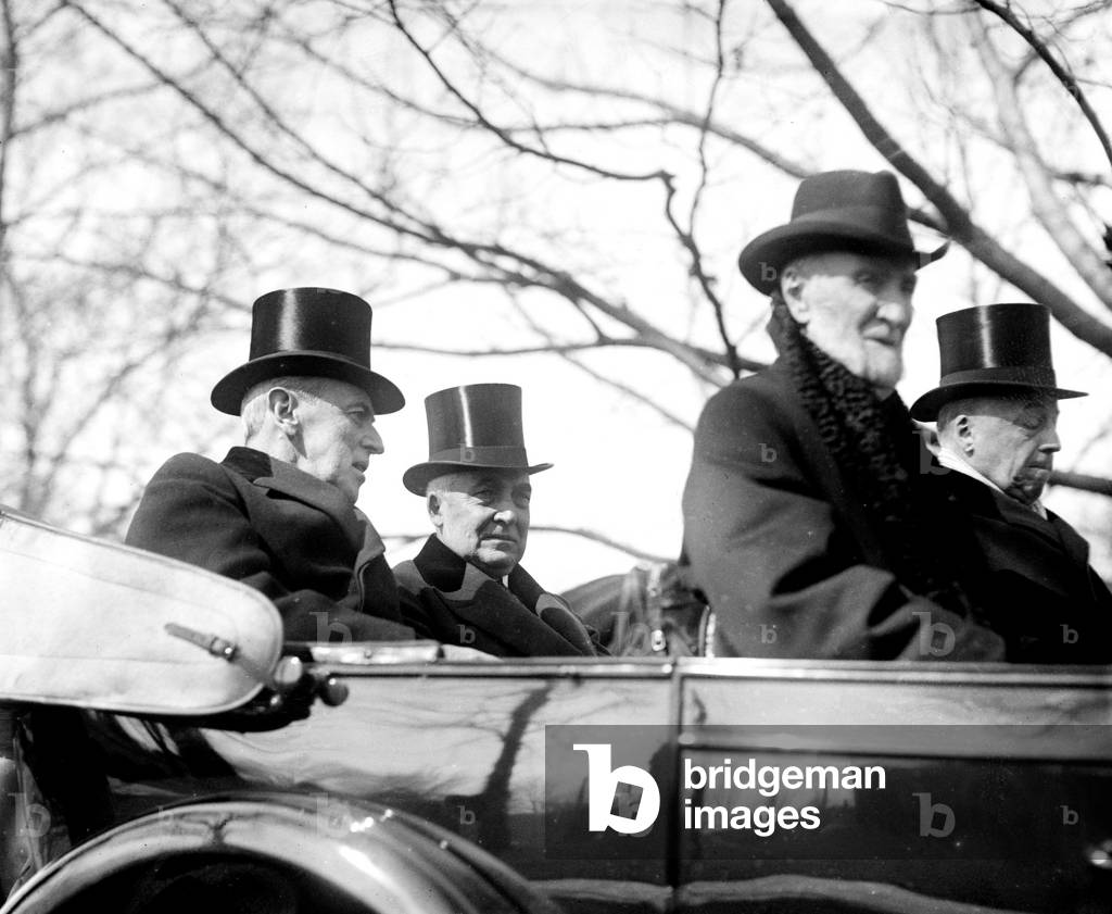 Incoming President Warren G. Harding (1865-1923) riding in open convertible to his inauguration with Presidential Woodrow Wilson (1856-1924), March 4, 1921. In front seats are Joseph Cannon and Philander Knox