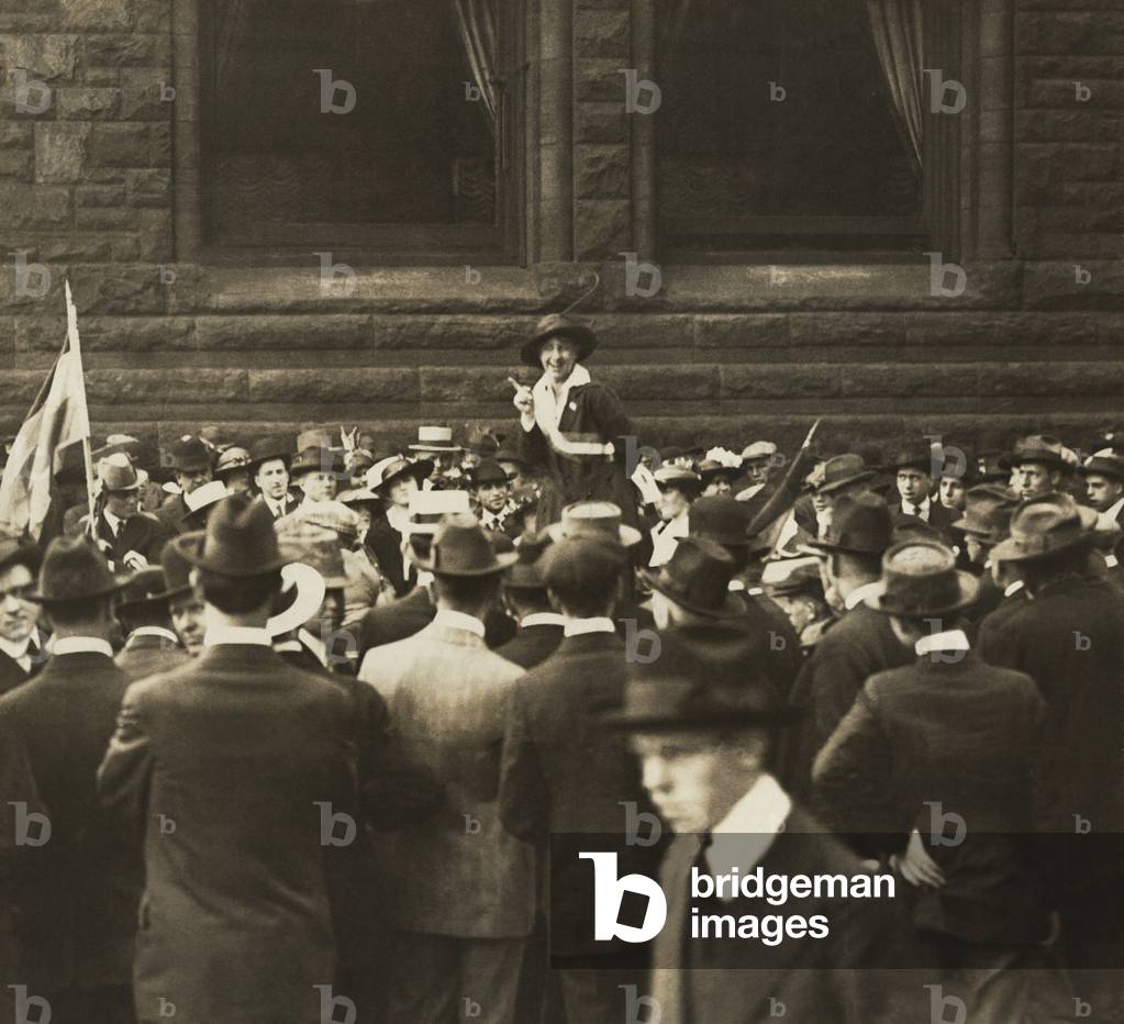 Suffragist Mabel Vernon speaking to large crowd of men an Open-Air Meeting in Chicago. In addition to her gifts as a speaker for the National Women's Party, she organized demonstrations and was herself arrested and imprisoned in 1917