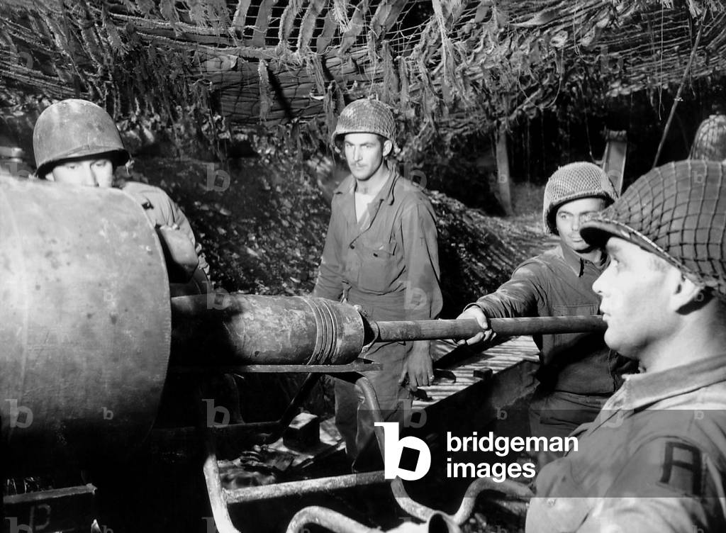 American gunners load a shell into the barrel of a gun M1 155mm 'Long Tom' in France. June-Sept., 1944. World War 2