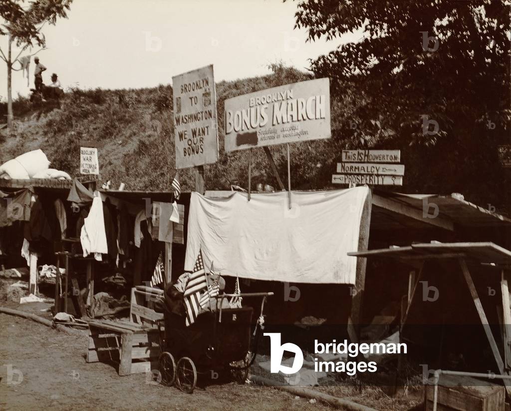 Encampment shanties of Brooklyn veterans in the Bonus Expeditionary Forces in Washington, D.C. Signs read: Brooklyn Bonus March; We Want Our Bonus; This is Hoovertown. Summer, 1932