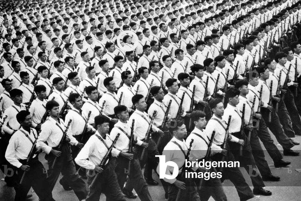One young woman soldier (circled) marches among hundreds of men during a parade in in Communist China. Oct. 27, 1961