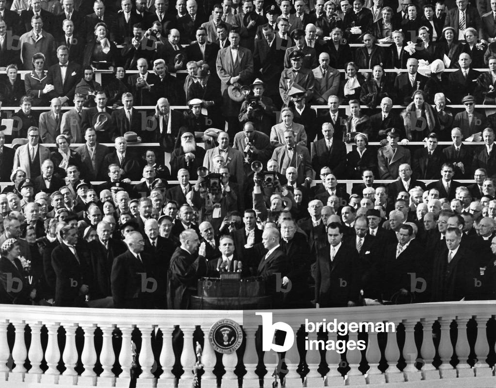 Chief Justice Fred Vinson administers the Oath of Office to Dwight Eisenhower. Jan. 20, 1953. Audience includes invited guests, Presidential families, and senior members of Congress.