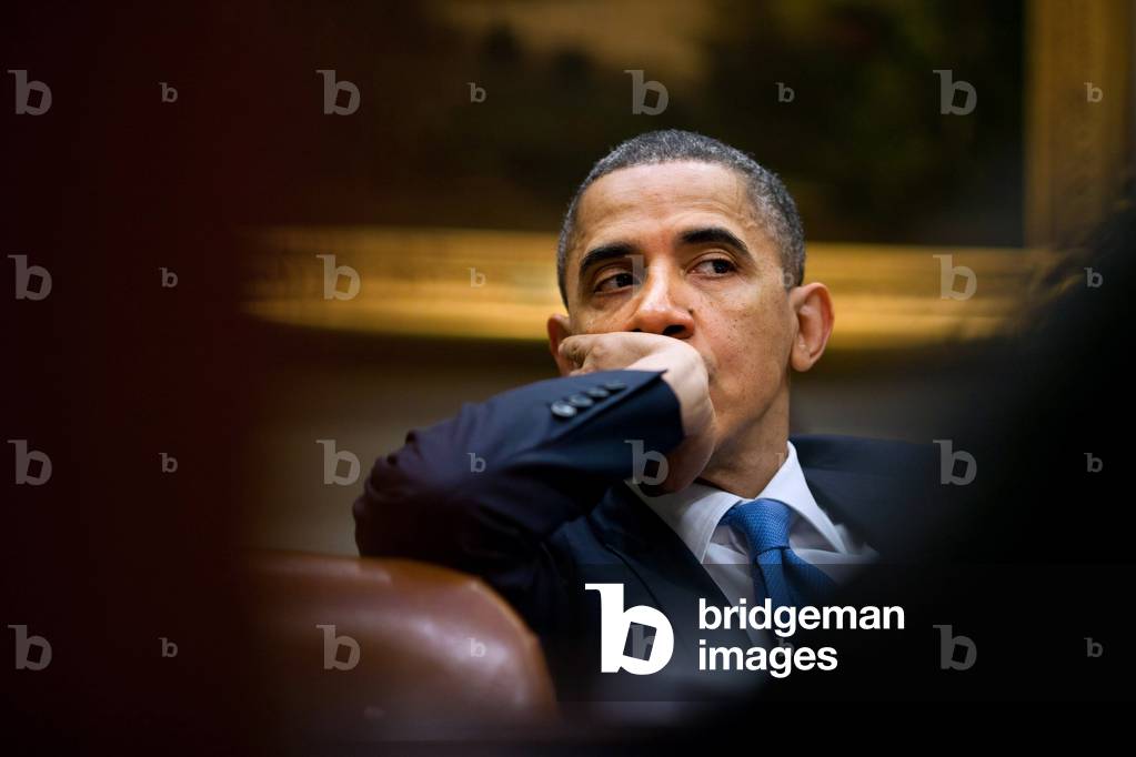 President Barack Obama listens during a staff meeting in the Roosevelt Room of the White House. Dec. 22 2010.,