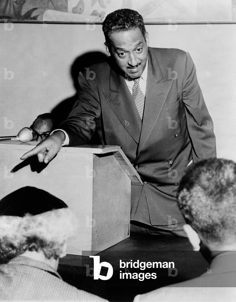 Thurgood Marshall: Thurgood Marshall (1908-1993), Chief Counsel for the National Assn. for the Advancement of Colored People, talking to newsmen in New York City. 1955 (b/w photo)