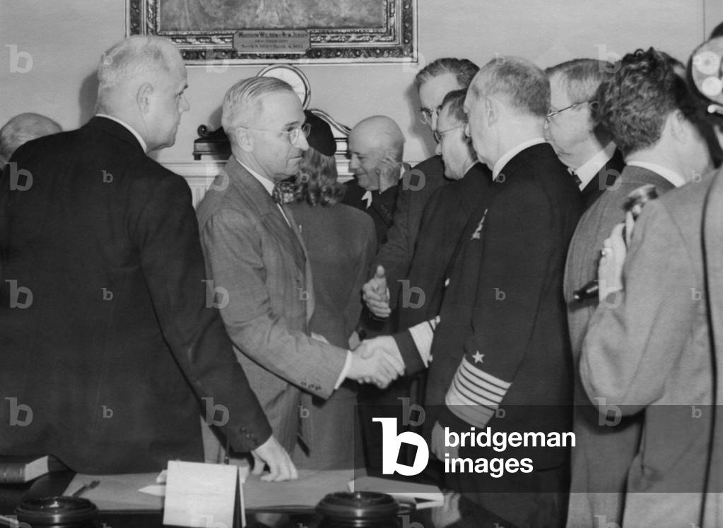 A solemn Harry Truman shakes hands with Admiral William Leahy after being sworn in as President. With George Marshall, Leahy had been FDR's top advisor during WW2.