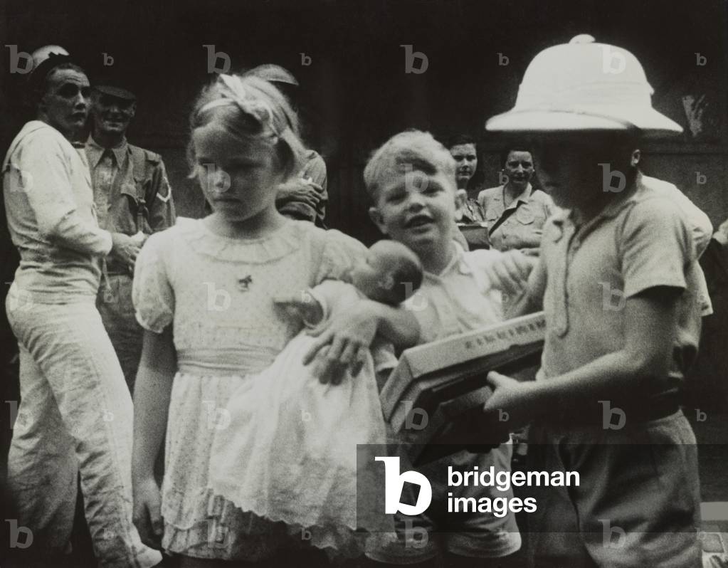 Children clutching their toys as they evacuate from Singapore before the arrival of the Japanese. c. Feb. 1942. World War 2