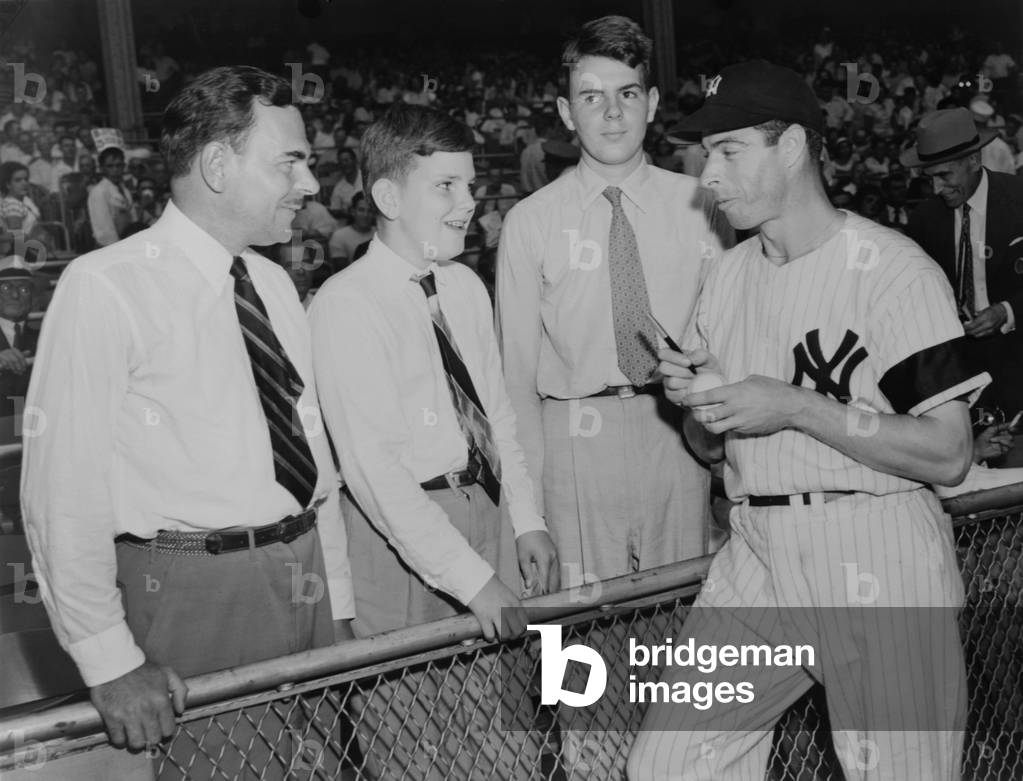Joe Di Maggio autographs baseball for Gov. Thomas Dewey's sons, Tommy and Johnny. 1948.