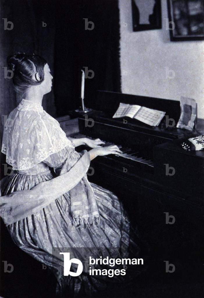 Woman playing a spinet piano. 1900 photograph by Frances Stebbins Allen