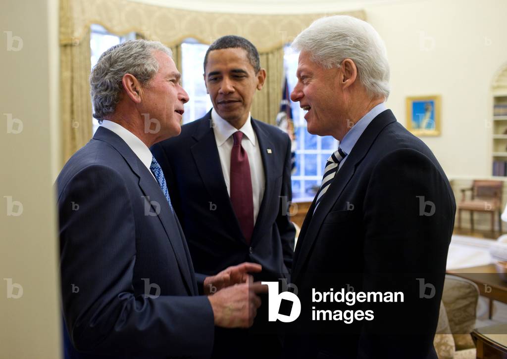 President Obama listens to a conversation between former Presidents Bill Clinton and George W. Bush after recruiting them to help earthquake stricken Haiti. Jan. 16 2010. (BSWH_2011_8_165)