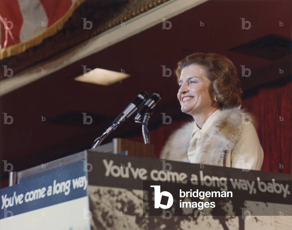 Betty Ford speaks during a Candidates' Luncheon sponsored by Republican Women Power of Illinois. The podium posts a feminist slogan 'You've Come A Long Way Baby.' 1976