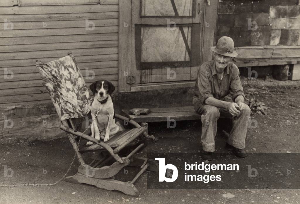 During the Great Depression foreclosed farmers moved to nearby towns Hoovervilles. Photo shows former farmer William Swift in his squatter shack in Circleville, Ohio. 1938 photo by Ben Shahn