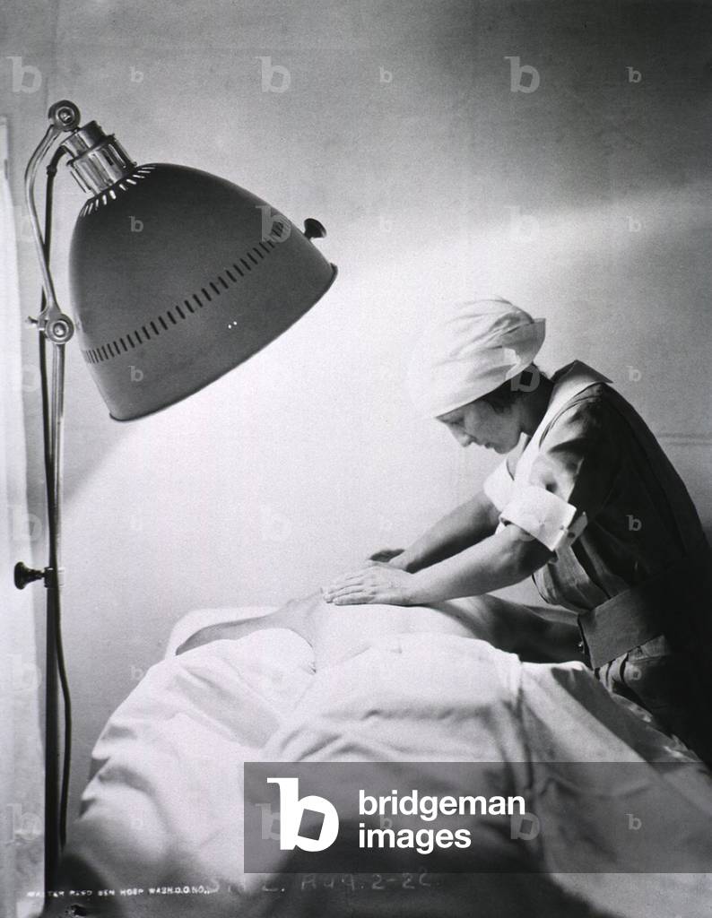 Nurse giving back rub to a patient in Walter Reed General Hospital. 1922