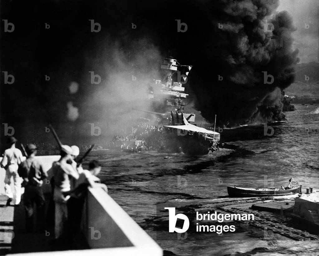 Pearl Harbor: Battered by aerial bombs and torpedoes, the U.S.S. California is evacuated as sailors and soldiers look on, December 7, 1941