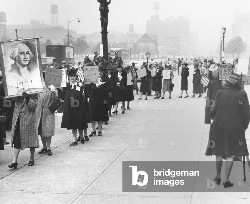 Female isolationists picket British Ambassador, Lord Halifax in Cleveland, Nov. 6, 1941. They carry signs reading: Halifax is a War Monger; Give Us Back Our White House