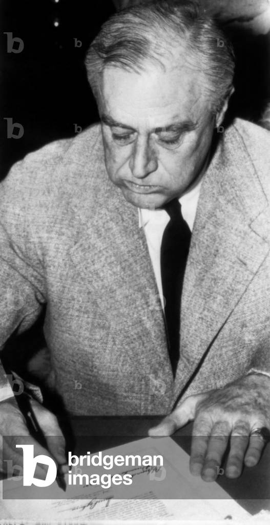President Franklin D. Roosevelt (1882-1945), U.S. President 1933-1945, signing the declaration of war against Italy, December 11, 1941