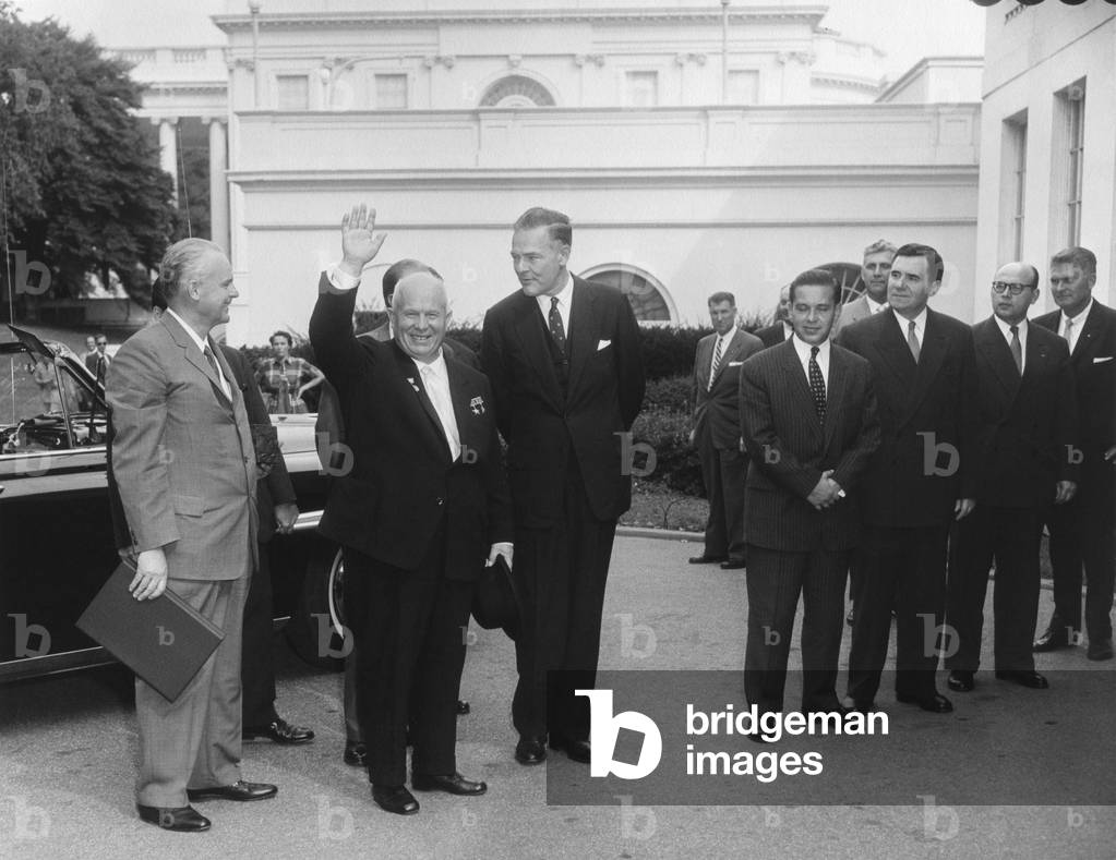 Soviet Premier Nikita Khrushchev waves as he arrives at the White House, Sept. 15, 1959. To his left is U.S. Ambassador to the UN, Henry Cabot Lodge. USSR Minister of Foreign Affairs, Andrei Gromyko, is third from right.
