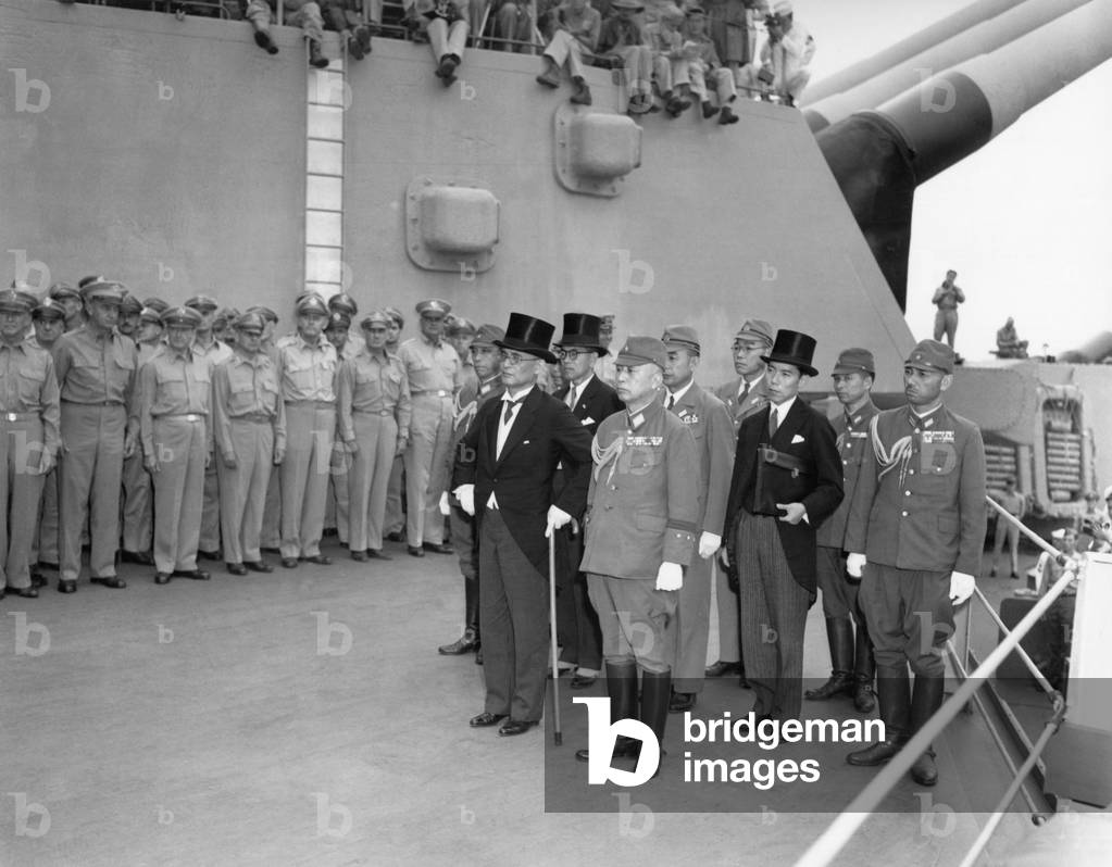 Japanese surrender signatories arrive aboard the USS MISSOURI in Tokyo Bay. Japanese Foreign Minister Mamoru Shigemitsu, in front with top hat, would sign the surrender. Sept. 2, 1945. World War 2