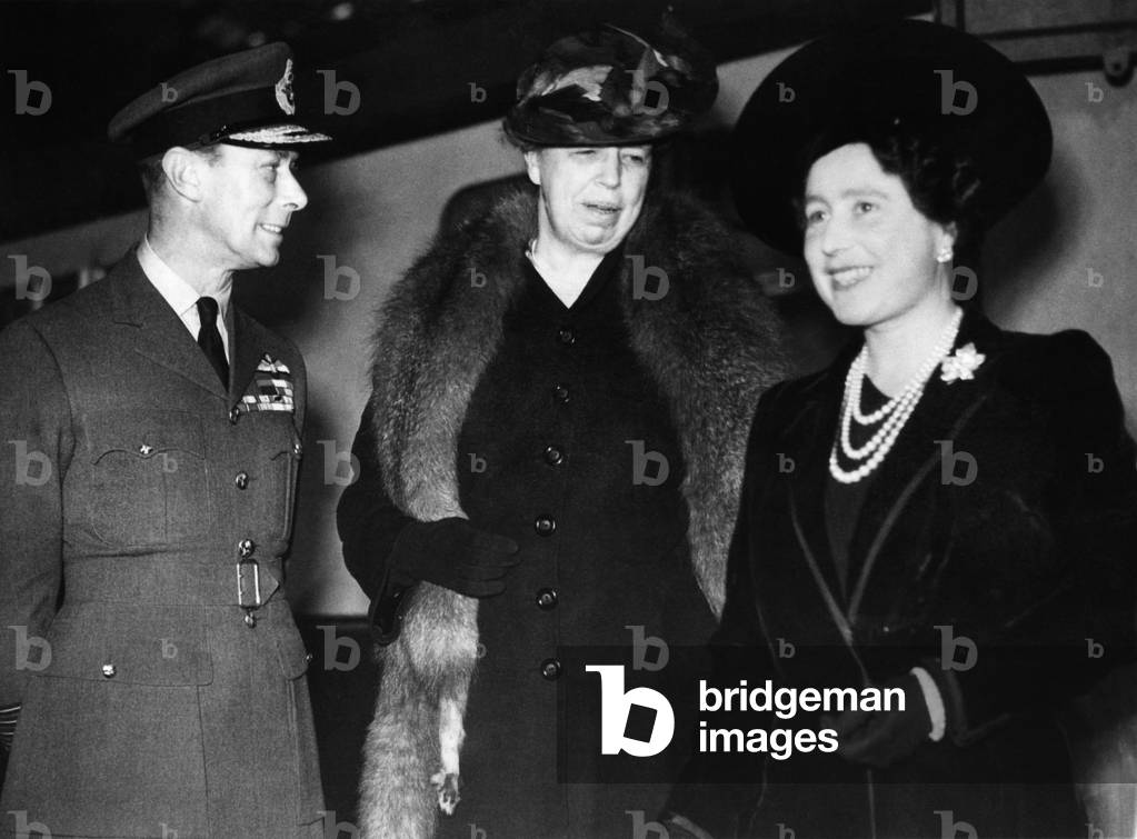 World War II. King George VI of England greets First Lady Eleanor Roosevelt with Queen Consort (future Queen Mother) Elizabeth of England, on Roosevelt's arrival to tour US forces, London, Great Britain, 1943