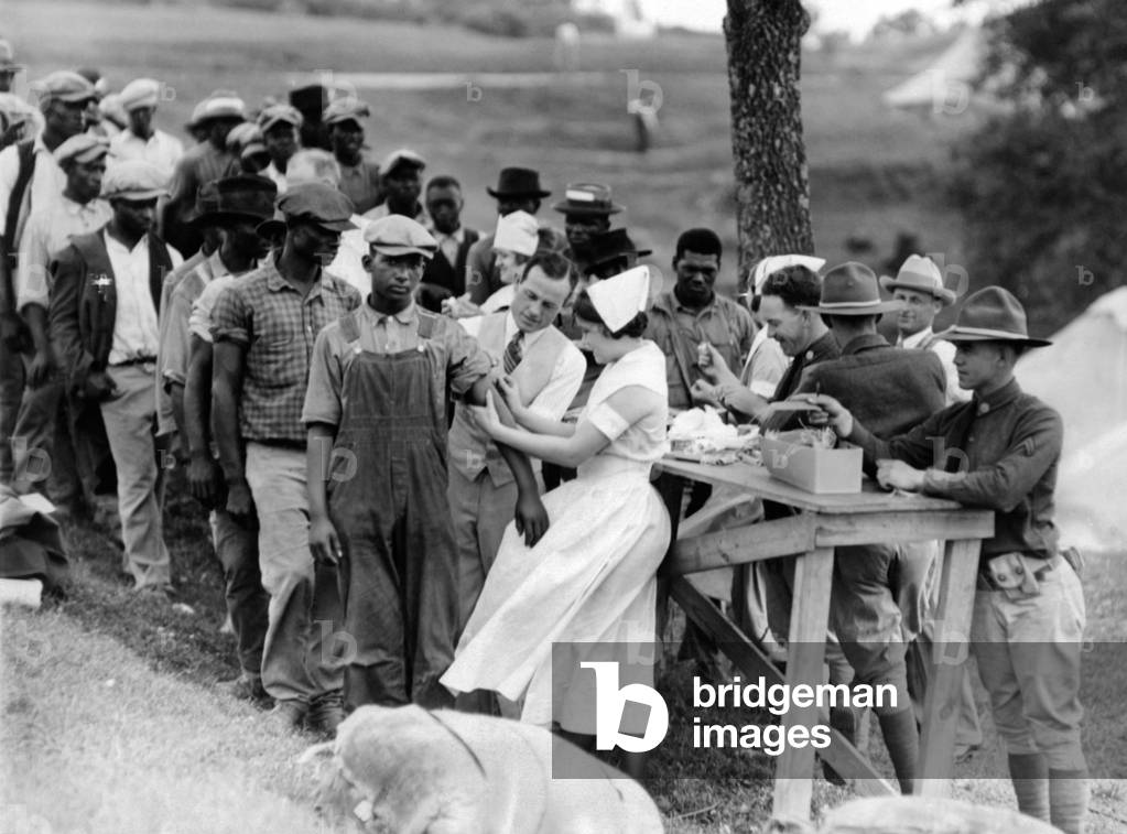 African American flood refugees vaccinated for typhoid at Camp Louisiana, near Vicksburg. Many would have joined the 'Great Migration' to northern cities, but authorities isolated them in unhealthy camps until the flood subsided, hence preserving their low paid agricultural workforce. May 21, 1927