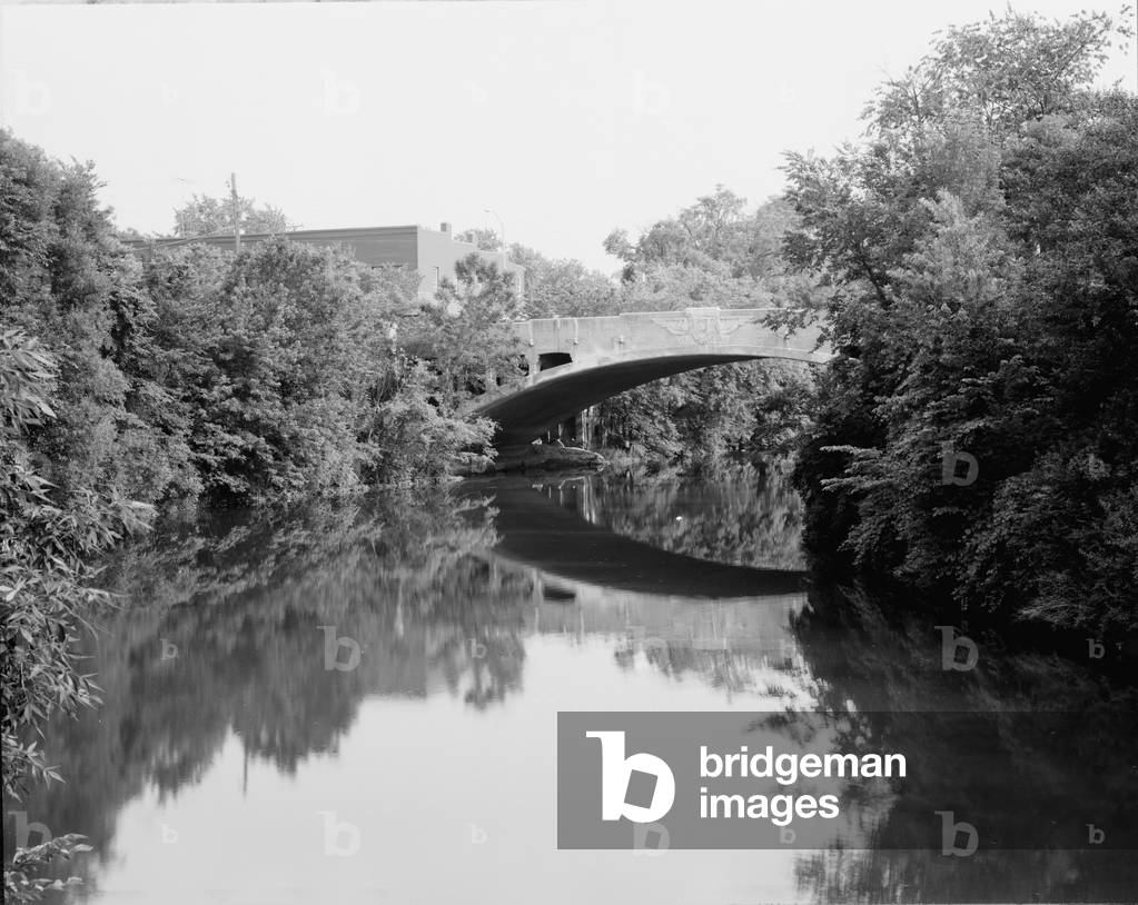 Bridges, West Sixth Street Bridge, a single open-spandrel, concrete barrel-arch bridge with a facade in Art Deco/Moderne style. Constructed in 1928, design by Charles S. Whitney. The bridge spans Root River at West Sixth Street & Kinzie Avenue, Racine Wisconsin, photograph c.1970s