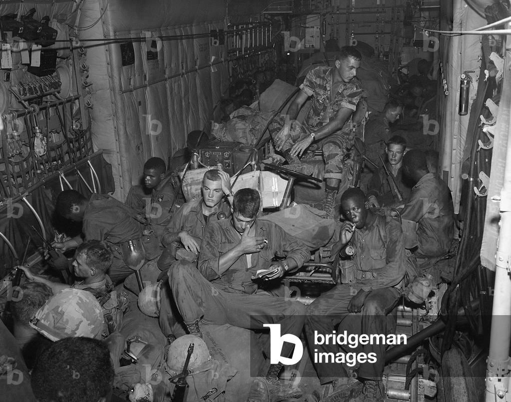 Vietnam War. 101st Airborne Division soldiers an a helicopter enroute to Phi Troung Air Base for a search and destroy mission during Operation Austin. April-May 1966