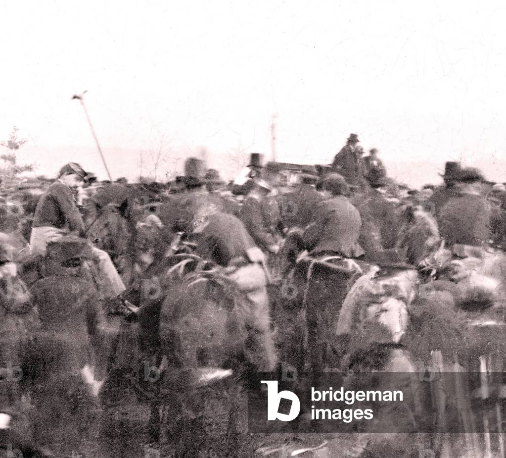 Abraham Lincoln (1809-1865) at the dedication ceremonies at the Soldiers' National cemetery, Gettysburg, Pennsylvania. Lincoln's The profile is visible as he rides on horseback through a corridor of troops after arriving at the cemetery. Nov. 19, 1863