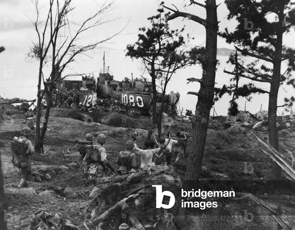 Marines guard Wolmi Island North Korean prisoners heading for landing craft. They were taken to Inchon for questioning, medical care and safe-keeping. Sept. 15, 1950. Korean War, 1950-53