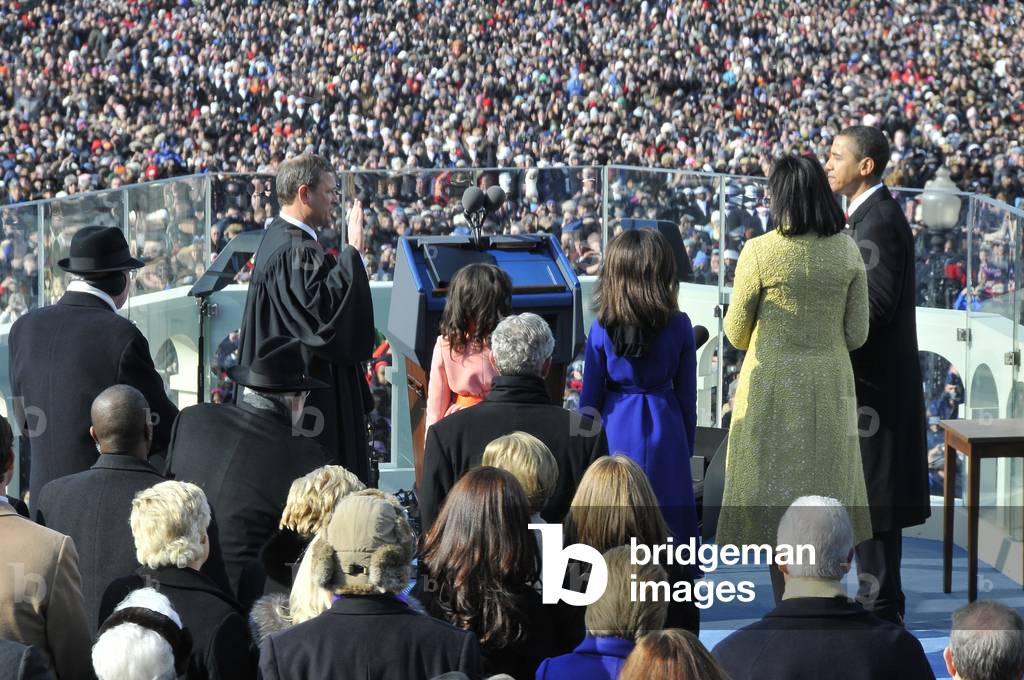 As his family watches Barack Obama is sworn in as the 44th president of the United States by Chief Justice Roberts. Jan. 20 2009. Picture includes back views of former presidents Clinton and George H.W. Bush 41 and their wives. (BSWH_2011_8_192)