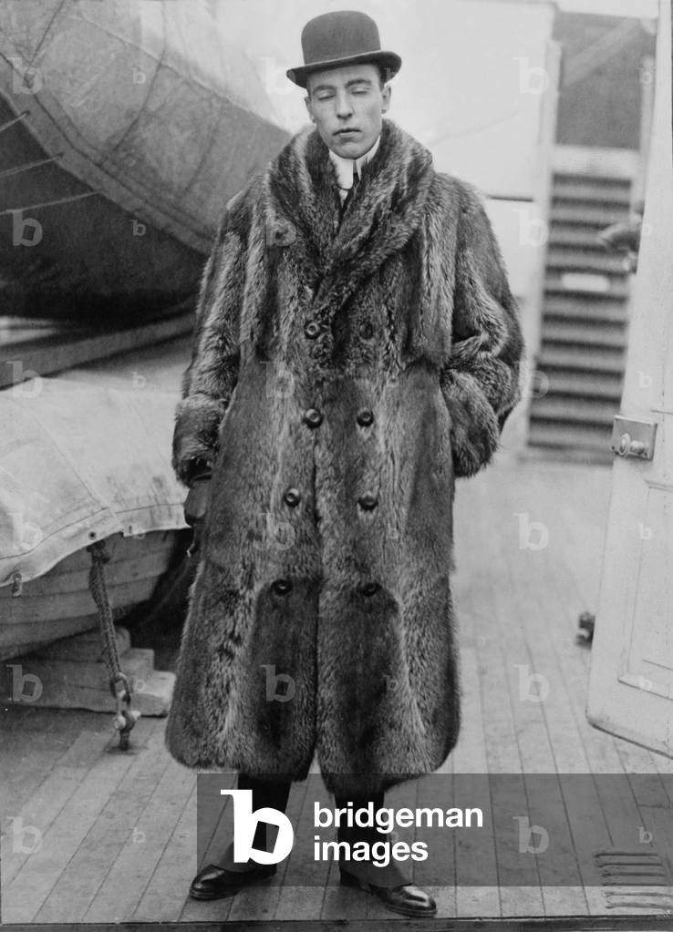 Vincent Astor (1891-1959), on deck of ship wearing fur coat. After his father, John Jacob Astor IV, died in the Titantic disaster, Vincent assumed a leadership role in the Astor family. c. 1920