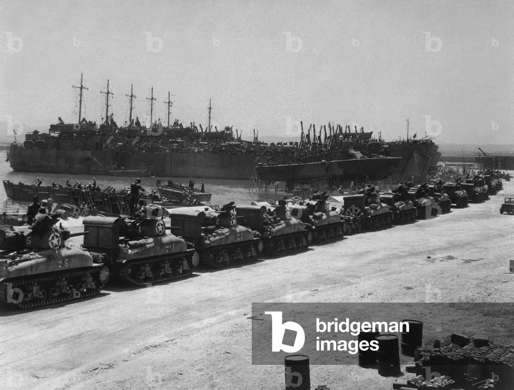 Two days before the Allied invasion of Sicily, tanks board landing craft. Ships are at the French Naval Base, La Pecherie, Tunisia. July 1943, World War 2